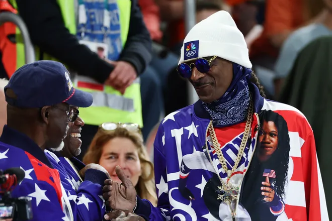 Snoop Dogg attends the Speed Skating Women's 500m whilst wearing a jacket in support of Erin Jackson of Team United States